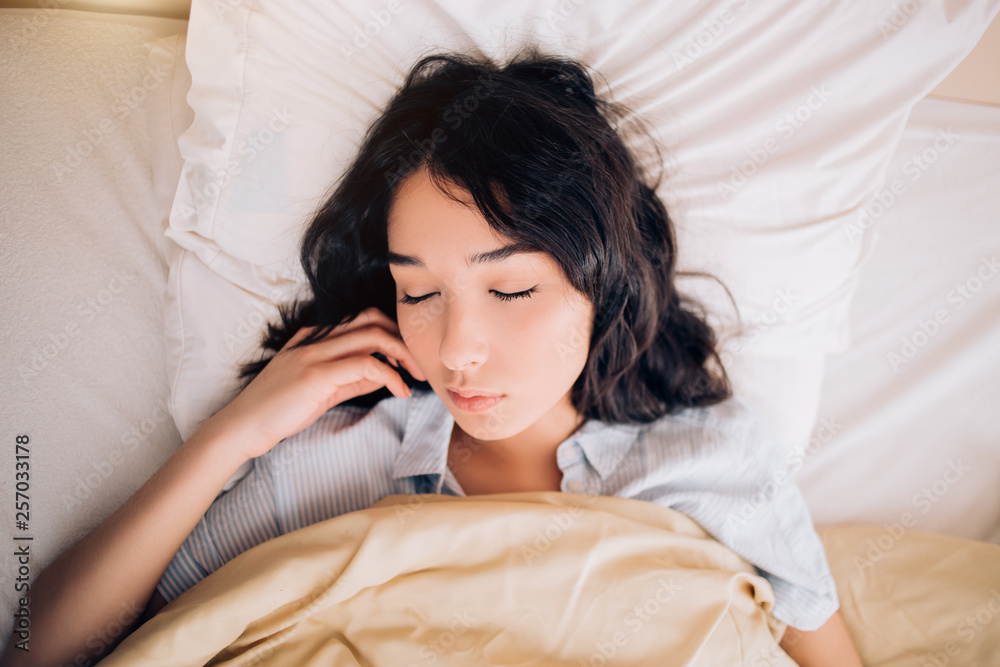 Young beautiful woman sleeping in bed, relaxing in the morning Young beautiful woman sleeping in bed, relaxing in the morning
