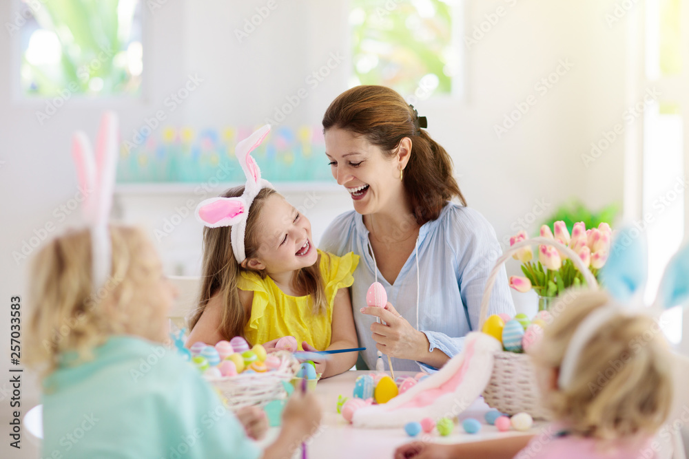Mother and kids, family coloring Easter eggs. Mother and kids, family coloring Easter eggs.