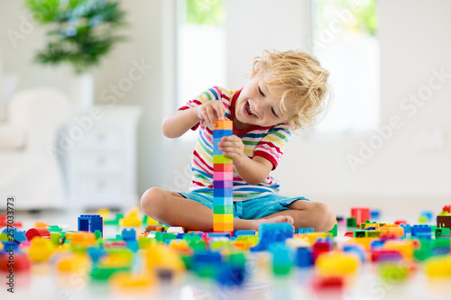 Child playing with toy bloc...