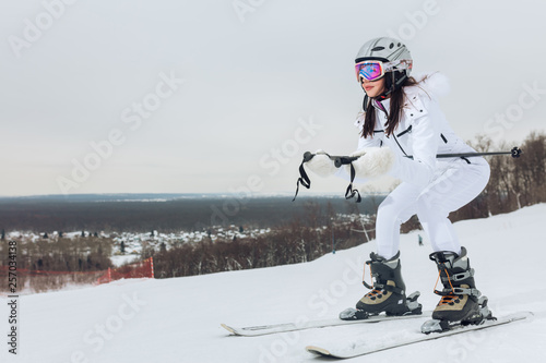 ambitious active awesome girl practising skiing outdoors, copy space, side view photo, health care, entertainment