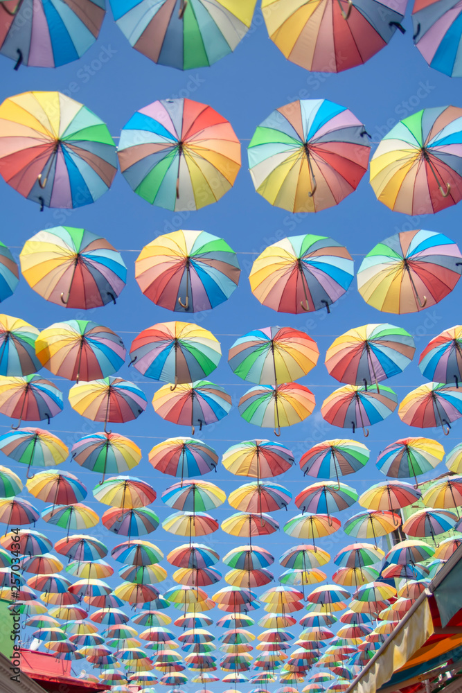 Obraz premium Colorful umbrellas background. Colorful umbrellas in the sky. Street decoration