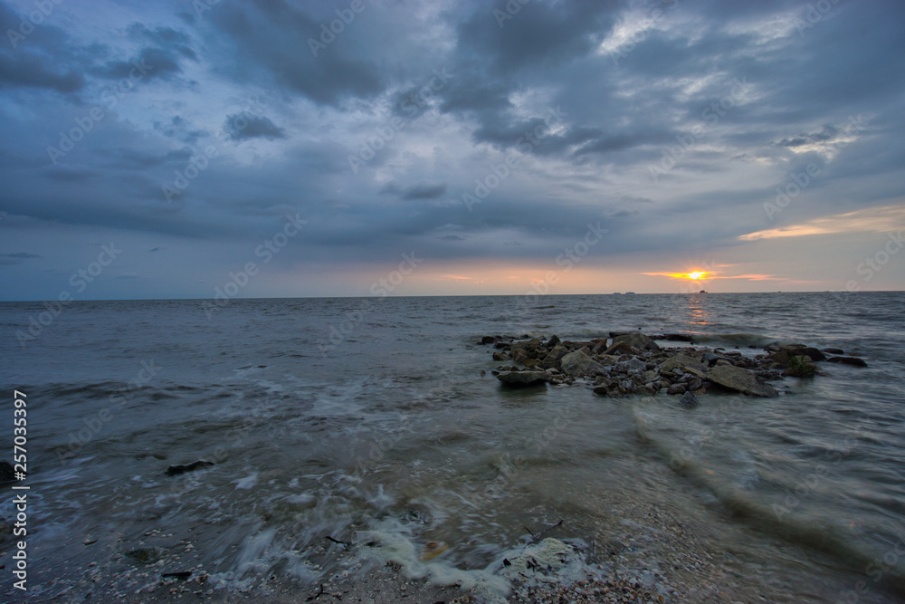 Peaceful beach view and waves during sunset at Jeram, Kuala Selangor Malaysia Peaceful beach view and waves during sunset at Jeram, Kuala Selangor Malaysia