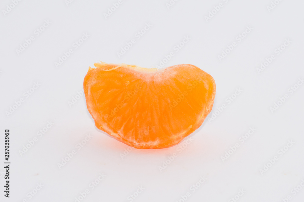 Mandarin slices on a white background, macro, space for copy Mandarin slices on a white background, macro, space for copy