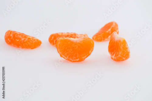 Mandarin slices on a white background, macro, space for copy