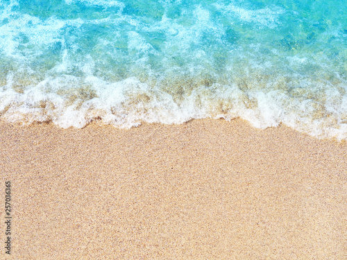 Sea sand beach, blue blurred wave. Summer vacation concept. Copy space