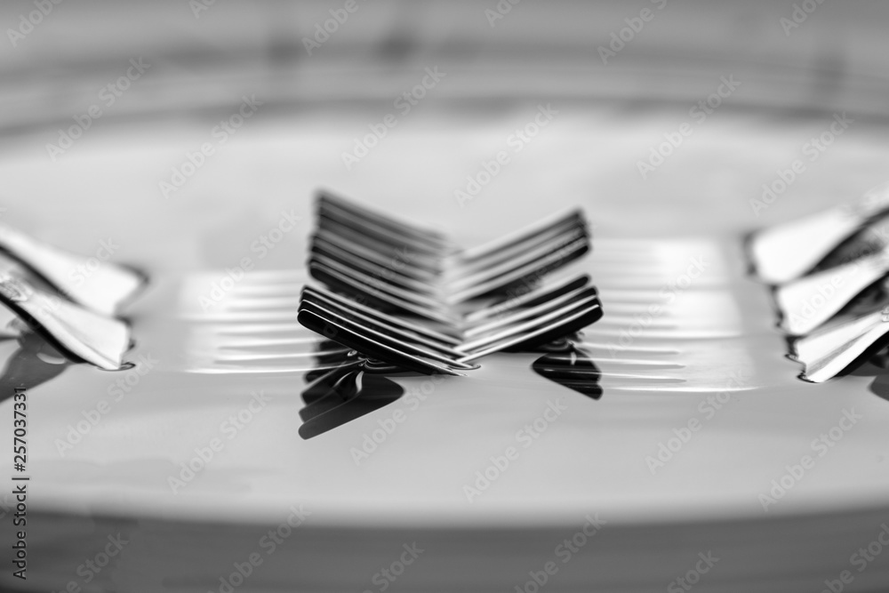 Forks on a dark surface in water. Forks on a dark surface in water.