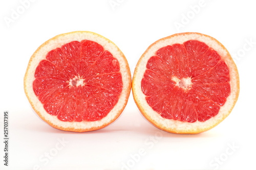 Slices of grapefruit macro closeup on white background