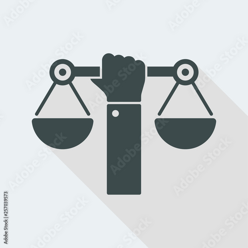 Hand holding a balance symbol of justice
