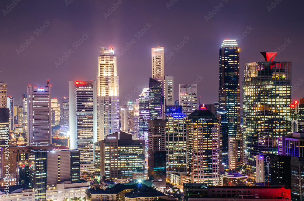 Aerial view of skyline business building and financial district  from rooftop, Modern towers and skyscrapers illuminated at night.
