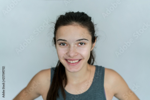 young girl laughs and smiles broadly with teeth