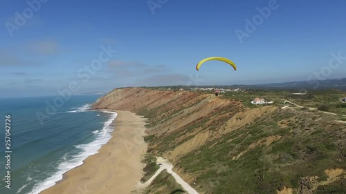 Close Up Aerial Shot of Paraglider Soaring Beach