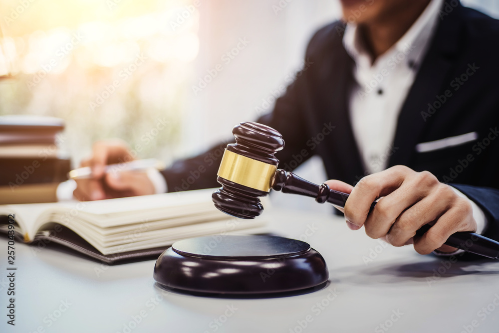 Focus of wooden gavel on table with male lawyer on background. justice and law ,attorney, court judge, concept. Focus of wooden gavel on table with male lawyer on background. justice and law ,attorney, court judge, concept.