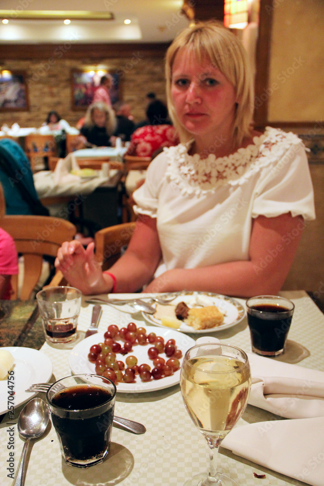 Beautiful woman eating in restaurant dish and drinking wine Beautiful woman eating in restaurant dish and drinking wine
