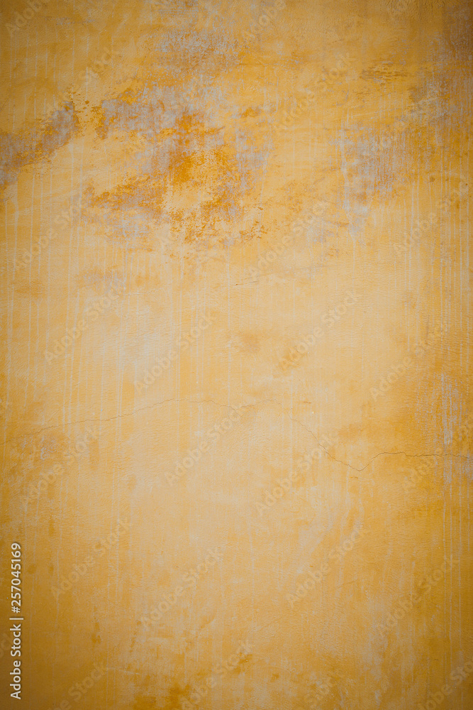 Old plaster walls painted gold. Texture of the wall. Old plaster walls painted gold. Texture of the wall.