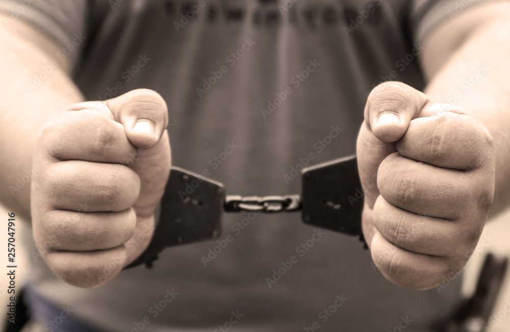 Fototapeta premium Man's hands in handcuffs. crime, arrest, criminal.