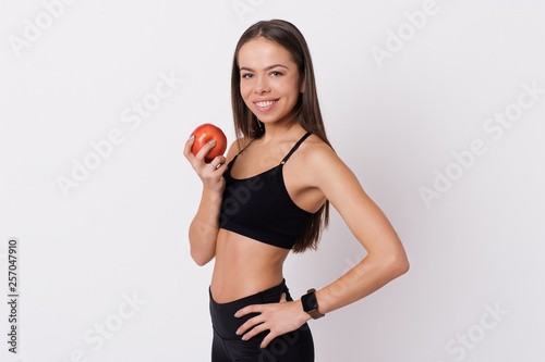 Slim and healthy young woman holding apple isolated on white background. Weight loss and diet concept