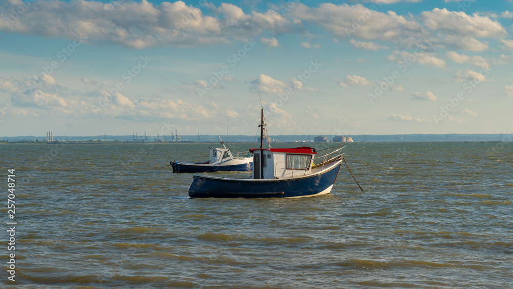 Boats on the shore of the River Thames, seen in Southend-on-Sea, Essex, England, UK