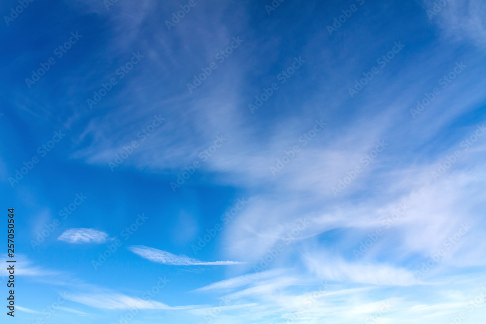 Bright, sunny winter sky with small clouds