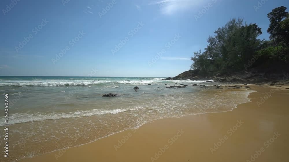 Secluded remote beach on an exotic island with waves lapping the shore and deep blue sky. Secluded remote beach on an exotic island with waves lapping the shore and deep blue sky.