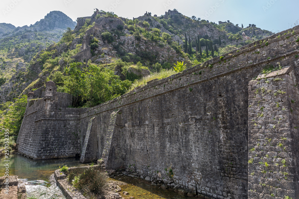 Fortification Wall Of Adriatic ancient Town Kotor in Montenegro. Castle walls and river