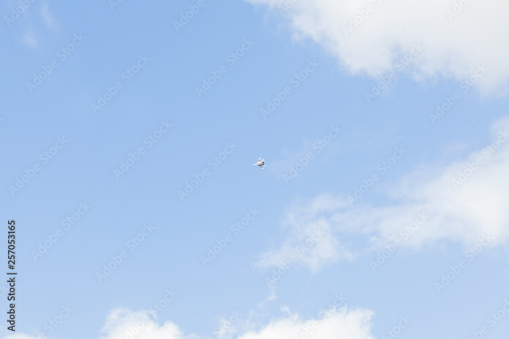 Military fighter in the blue sky with white clouds Military fighter in the blue sky with white clouds
