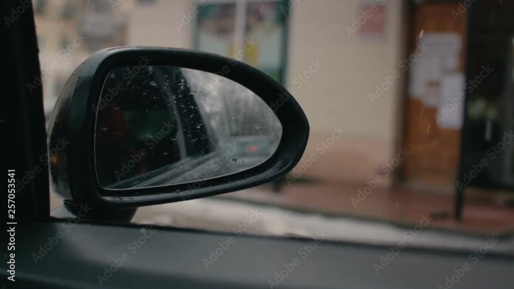 side mirror of the car. Reflection rear view. Humidity and slush on the street, sleet. Bad weather conditions side mirror of the car. Reflection rear view. Humidity and slush on the street, sleet. Bad weather conditions