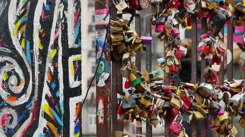 Love locks on metall gate of the Berlin Wall at East Side Gallery. 4k