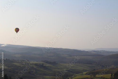 A hot air balloon at sunrise above the Chianti hills south of Florence in Tuscany © Marco Ramerini