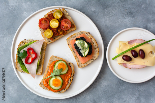Breakfast toasts with various toppings. Healthy bruschetta. Bread sandwich.