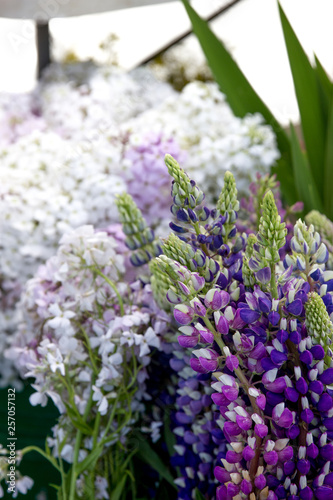 Friendly flower vendors sell large bouquets of bright fresh flowers at the downtown farmer s market.