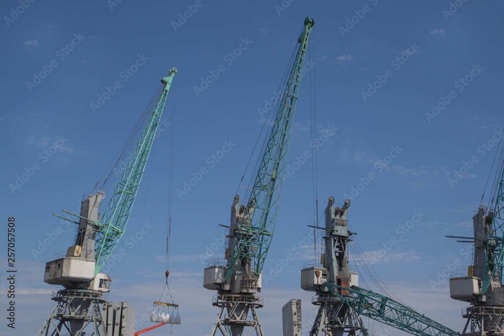 crane ship in export and import business and logistics. Shipping cargo to harbor by crane