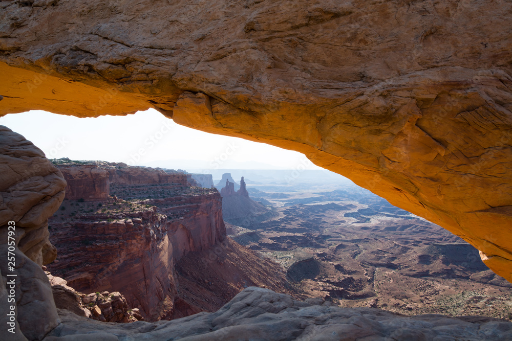 Mesa Arch framing an iconic view of the canyon landscape of Canyonlands National Park, Utah, USA.