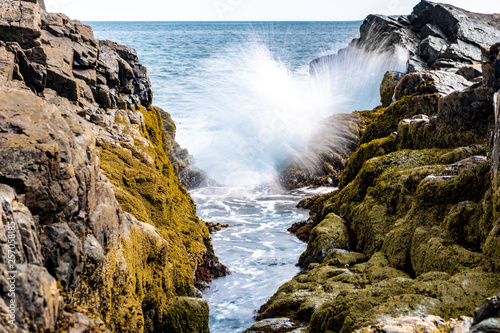 A wave splashing on rocks