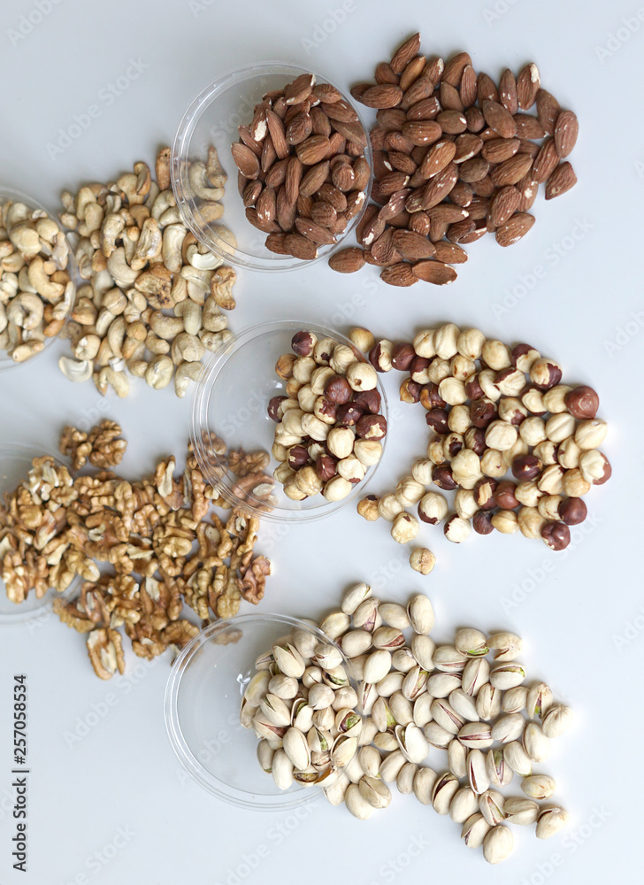 Healthy food. Nuts mix assortment on stone table top view. Collection of different legumes for background image close up nuts, pistachios, almond, cashew nuts, peanut, walnut. image Healthy food. Nuts mix assortment on stone table top view. Collection of different legumes for background image close up nuts, pistachios, almond, cashew nuts, peanut, walnut. image