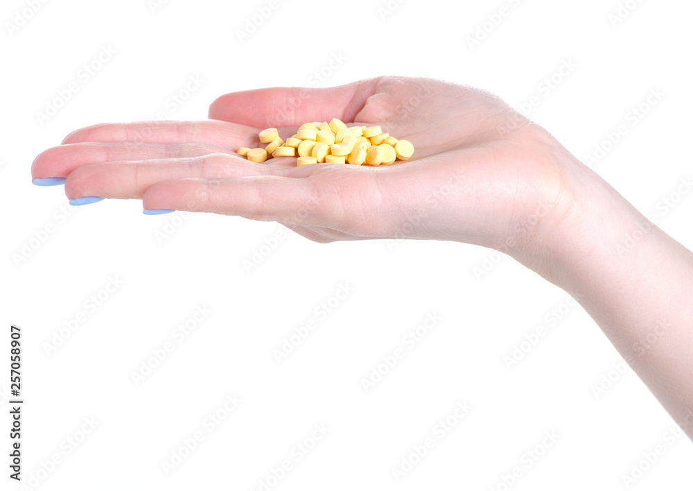 Yellow pills medicine pharmacy in hand on white background isolation Yellow pills medicine pharmacy in hand on white background isolation