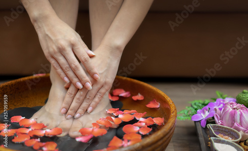 Female feet at spa pedicure procedure.Spa treatment and product for female feet and hand spa  selective and soft focus  copy space
