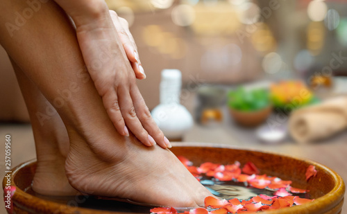 Female feet at spa pedicure procedure.Spa treatment and product for female feet and hand spa, selective and soft focus, copy space