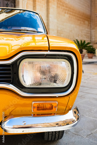 Close-up of the headlight of a classic 1971 FORD ESCORT MK1 GT