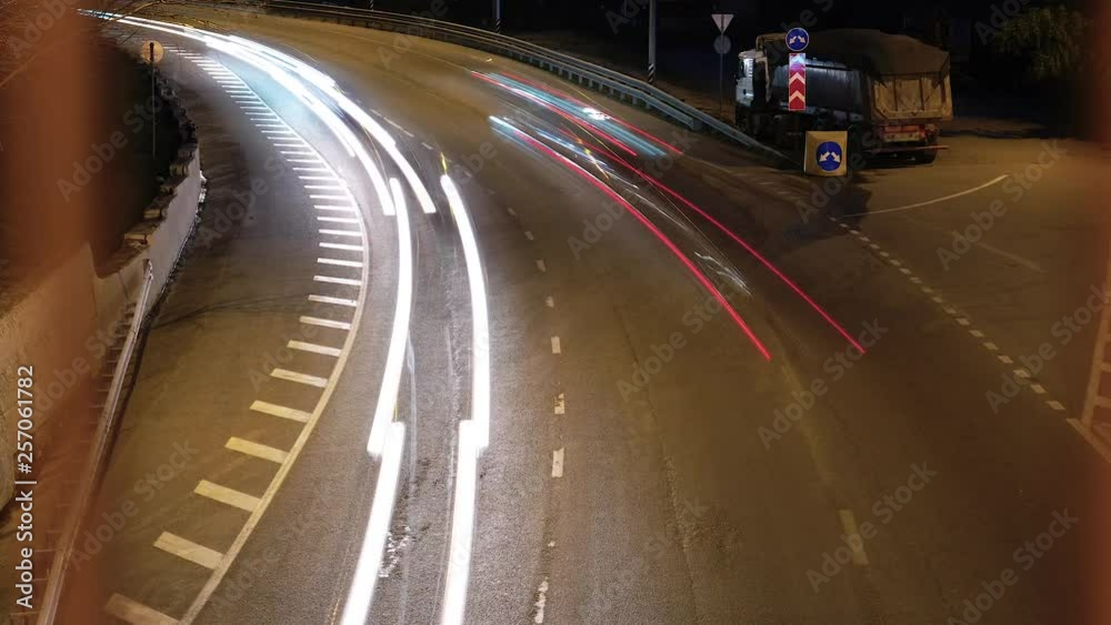 Timelapse shot of night road. City traffic. Evening illumination of the highway. The flow of cars on the turn. Timelapse shot of night road. City traffic. Evening illumination of the highway. The flow of cars on the turn.
