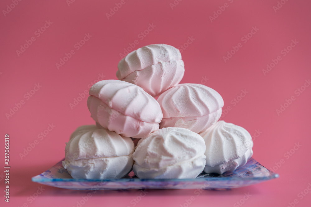 Pink and white marshmallows on a pink background. copy space Pink and white marshmallows on a pink background. copy space