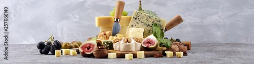 Panel kuchenny z motywem Cheese plate served with figs, various cheese on a platter on wood