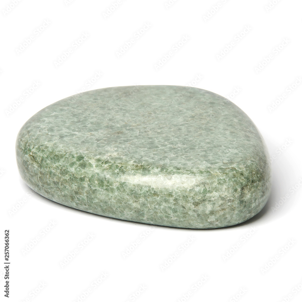 One greenish polished jadeite stone for spa massage isolated on white background One greenish polished jadeite stone for spa massage isolated on white background