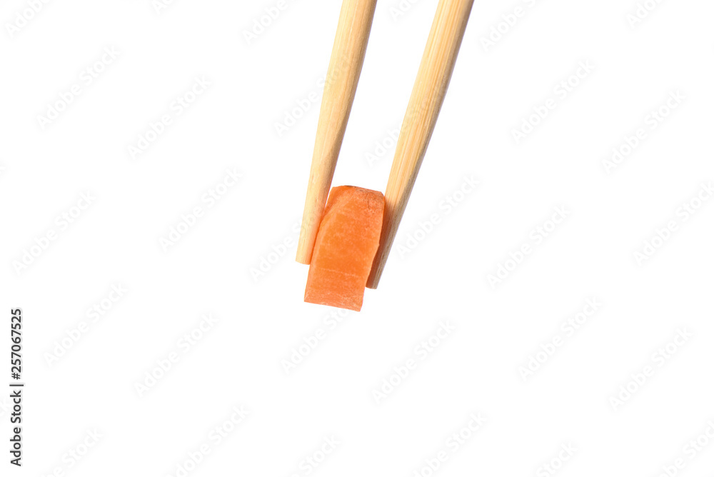 Chopsticks with a circle of ripe carrots isolated on white background. Chopsticks with a circle of ripe carrots isolated on white background.