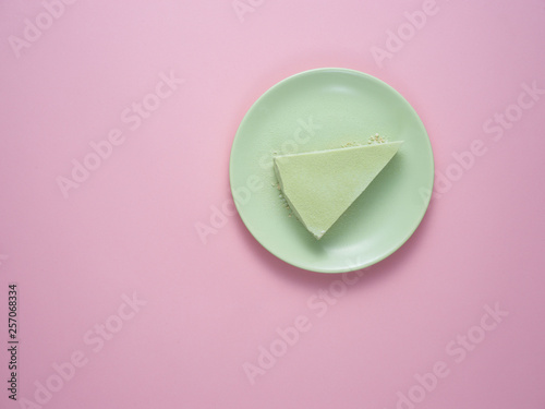 Green tea cheesecake on a green plate.