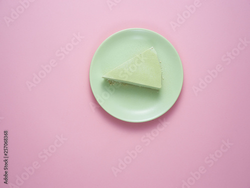 Green tea cheesecake on a green plate.