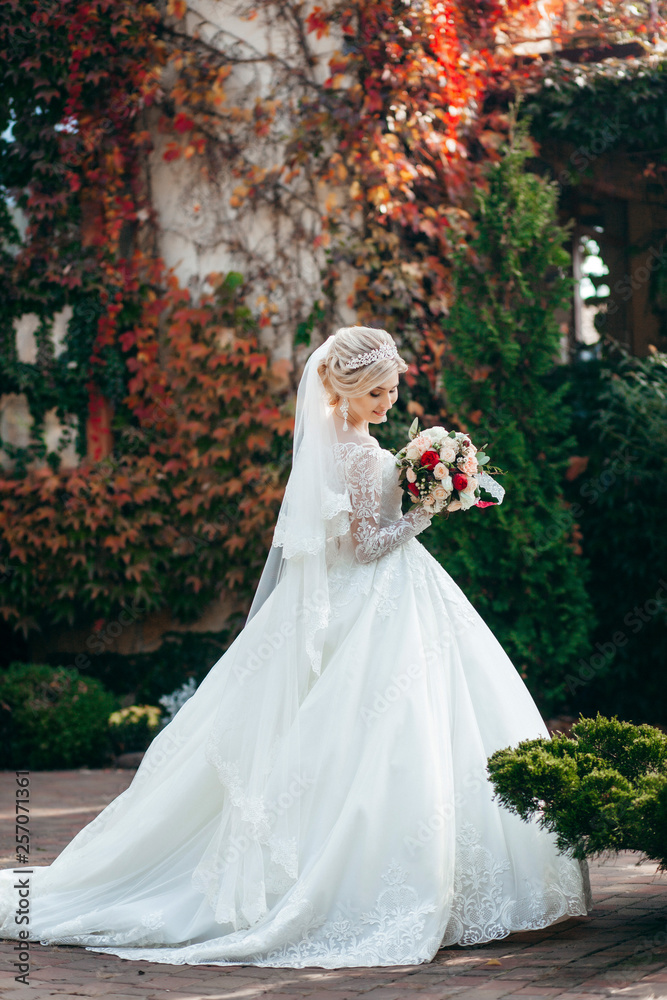 Fototapeta premium Portrait of a young beautiful bride with a bouquet
