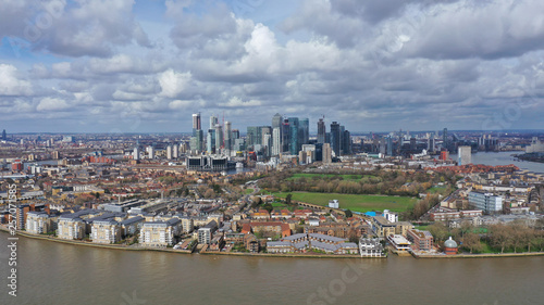 Aerial bird's eye view panoramic drone photo of Greenwich park with views to Canary Wharf and University of Greenwich with beautiful cloudy sky, Isle of Dogs, London, United Kingdom