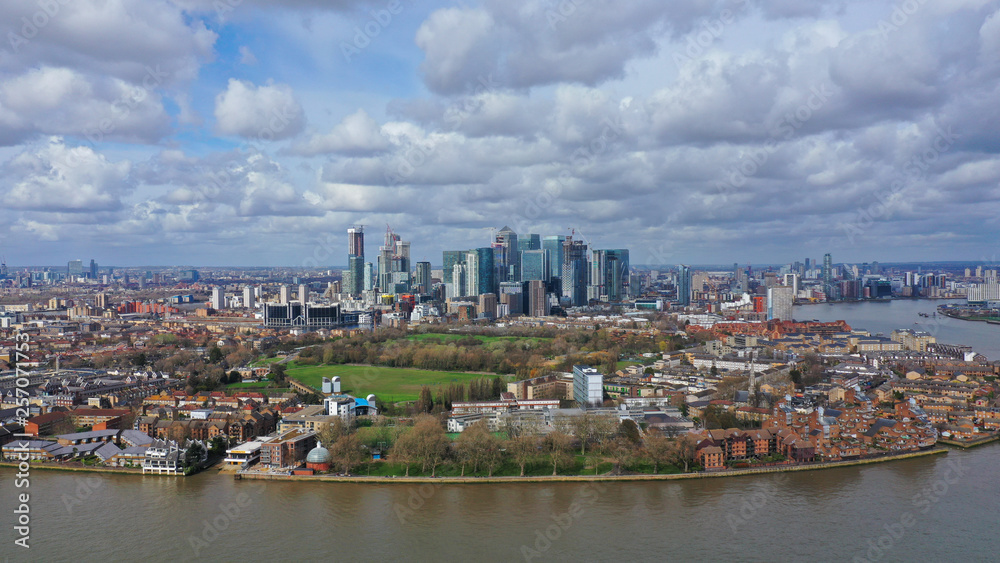 Naklejka premium Aerial bird's eye panoramic photo taken by drone of iconic Canary Wharf skyscraper complex and business district, Isle of Dogs, London, United Kingdom