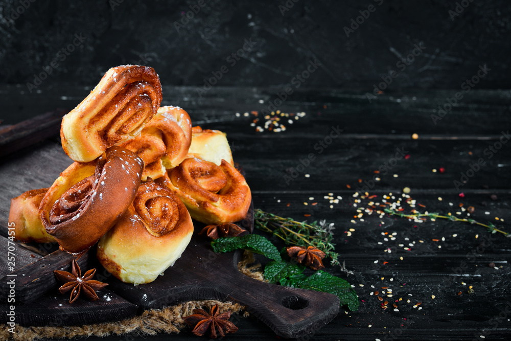Sweet buns with cinnamon. Top view. Free space for your text. Rustic style. Sweet buns with cinnamon. Top view. Free space for your text. Rustic style.