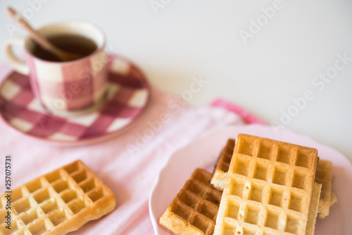 tea time with Belgian waffles, on pink napkin, white table, space for text